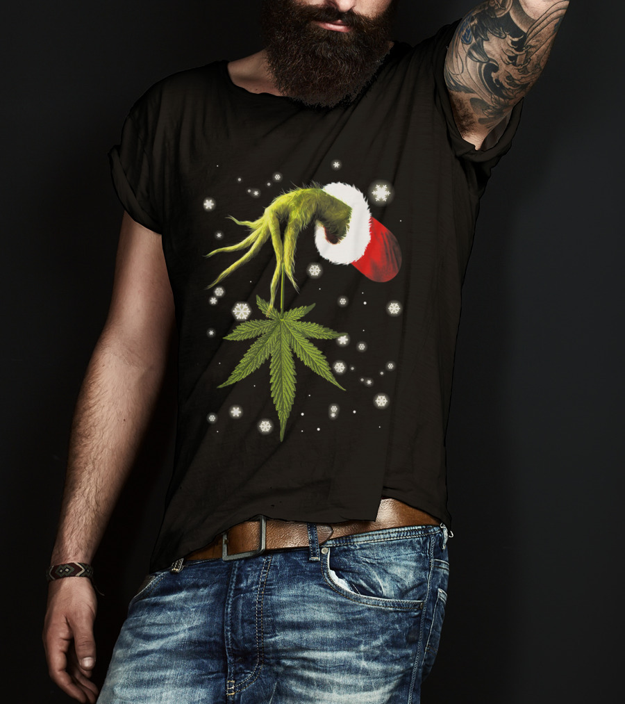 Grinch Hand Holding Cannabis Leaf With Santa Hat And Snowflakes T-Shirt