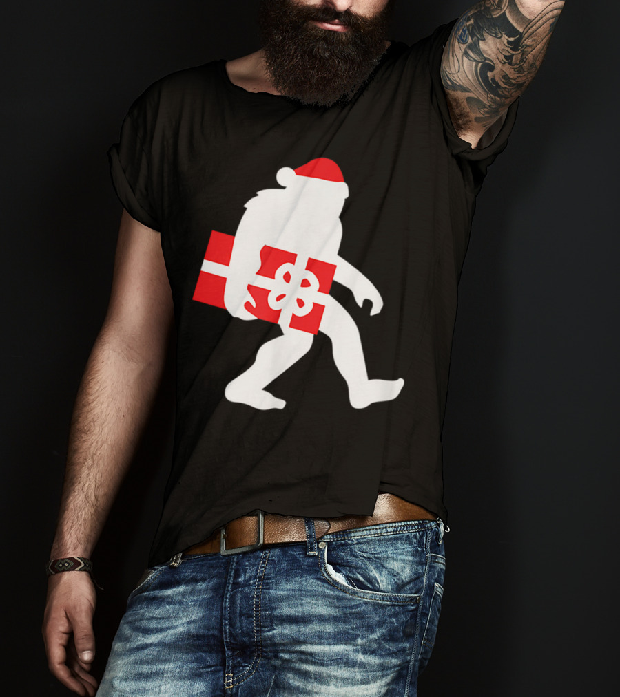 Nice Bigfoot Carrying Christmas Gift In Santa Hat T-Shirt