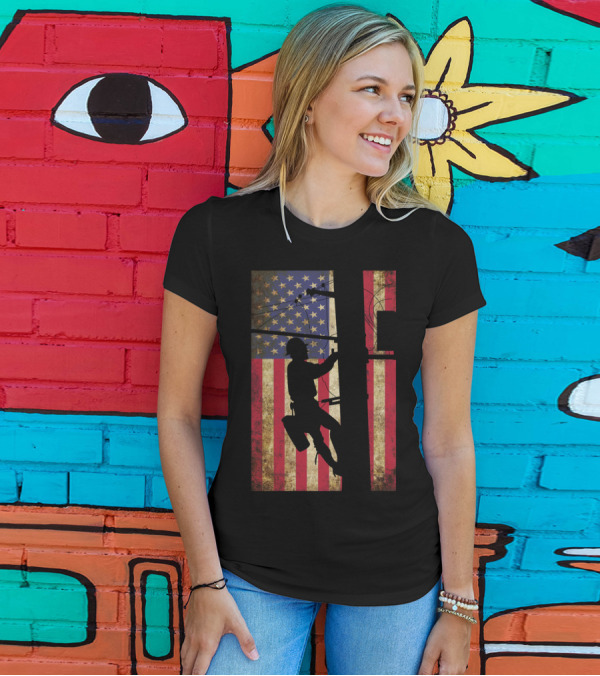 Lineman Climbing Electric Pole Against American Flag Background T-Shirt