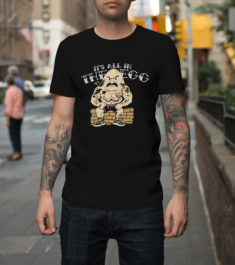 It's All In The Egg Muscular Cartoon Character With Mustache Sitting On Brick Wall T-Shirt