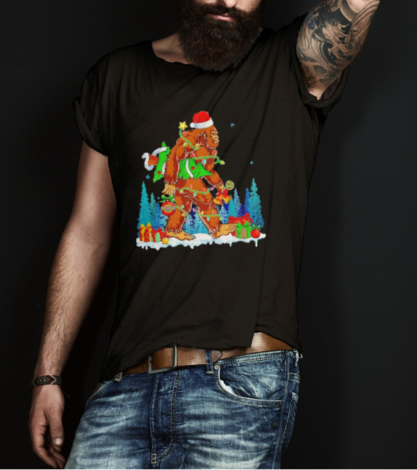 Bigfoot Santa Hugging Christmas Tree With Gifts And Snow Scene T-Shirt