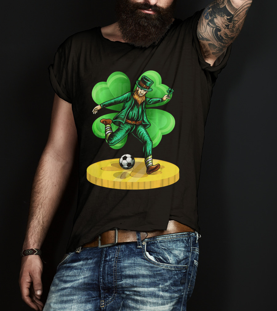 Leprechaun Kicking Soccer Ball On Gold Coin With Shamrock Background T-Shirt